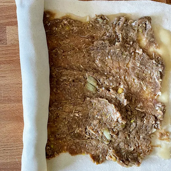 chinese beef and leek pie dough being rolled