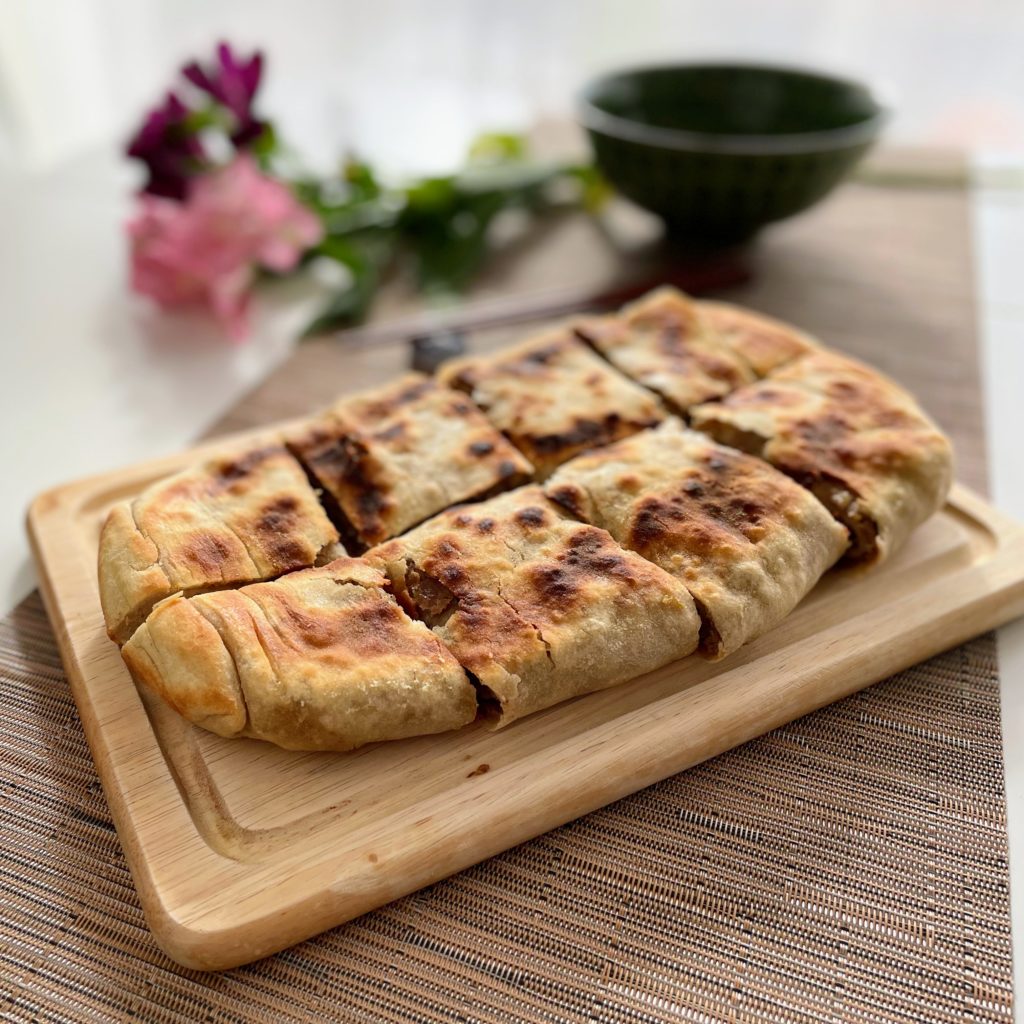 chinese beef and leek pie on wood