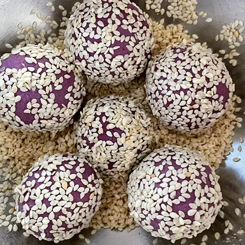 purple sweet potato jian dui covered in sesame seeds