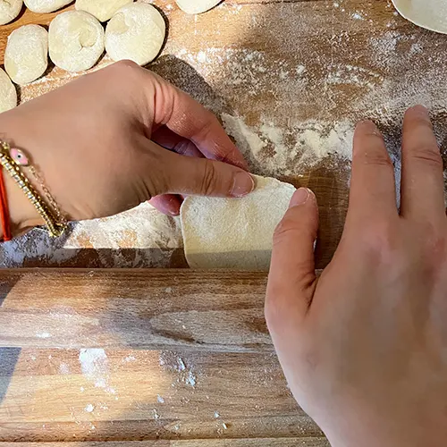 handmade chinese dumpling wrappers lifting the edge while rolling