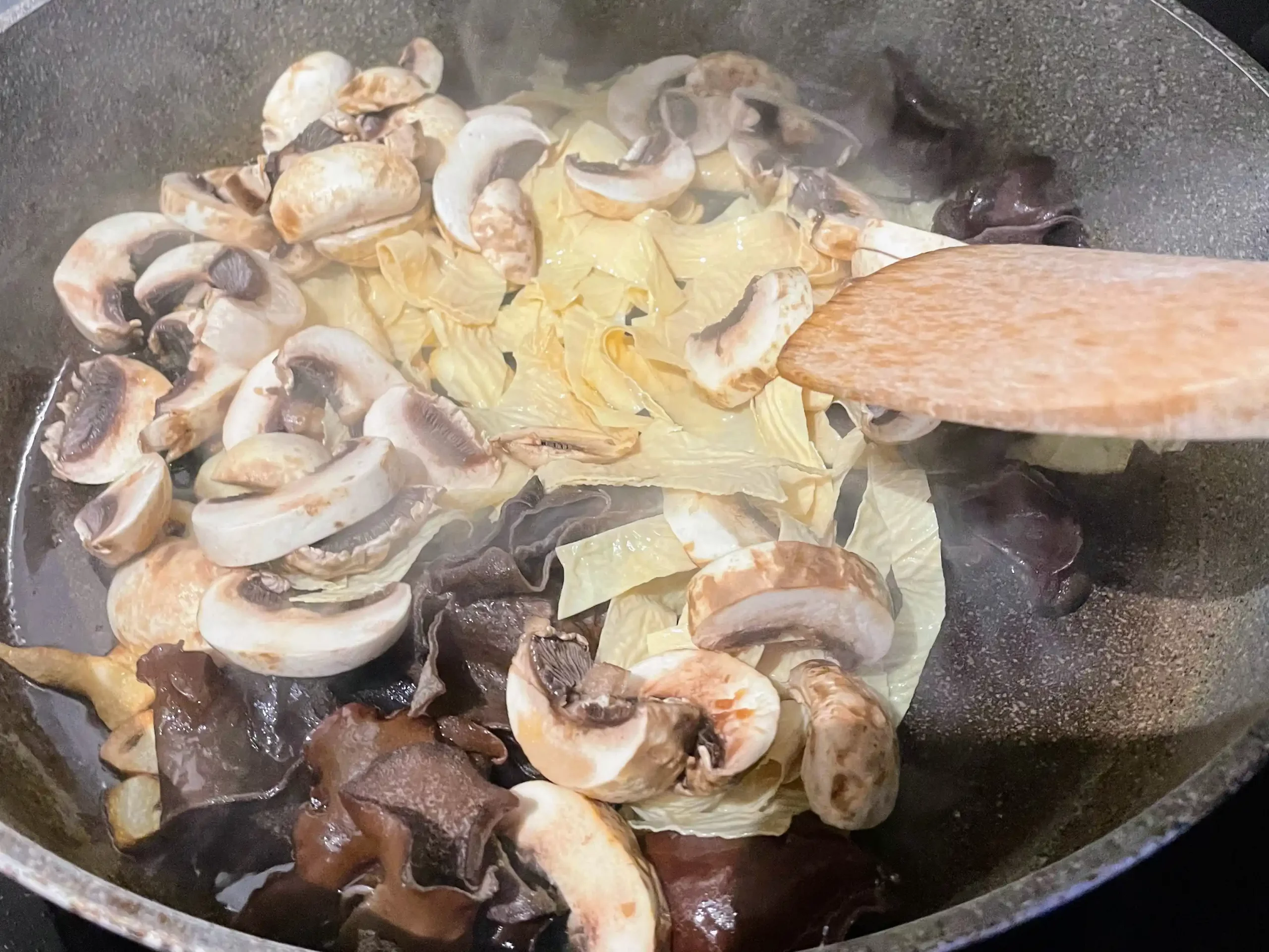 buddha's delight luo han zhai sliced mushrooms in pan
