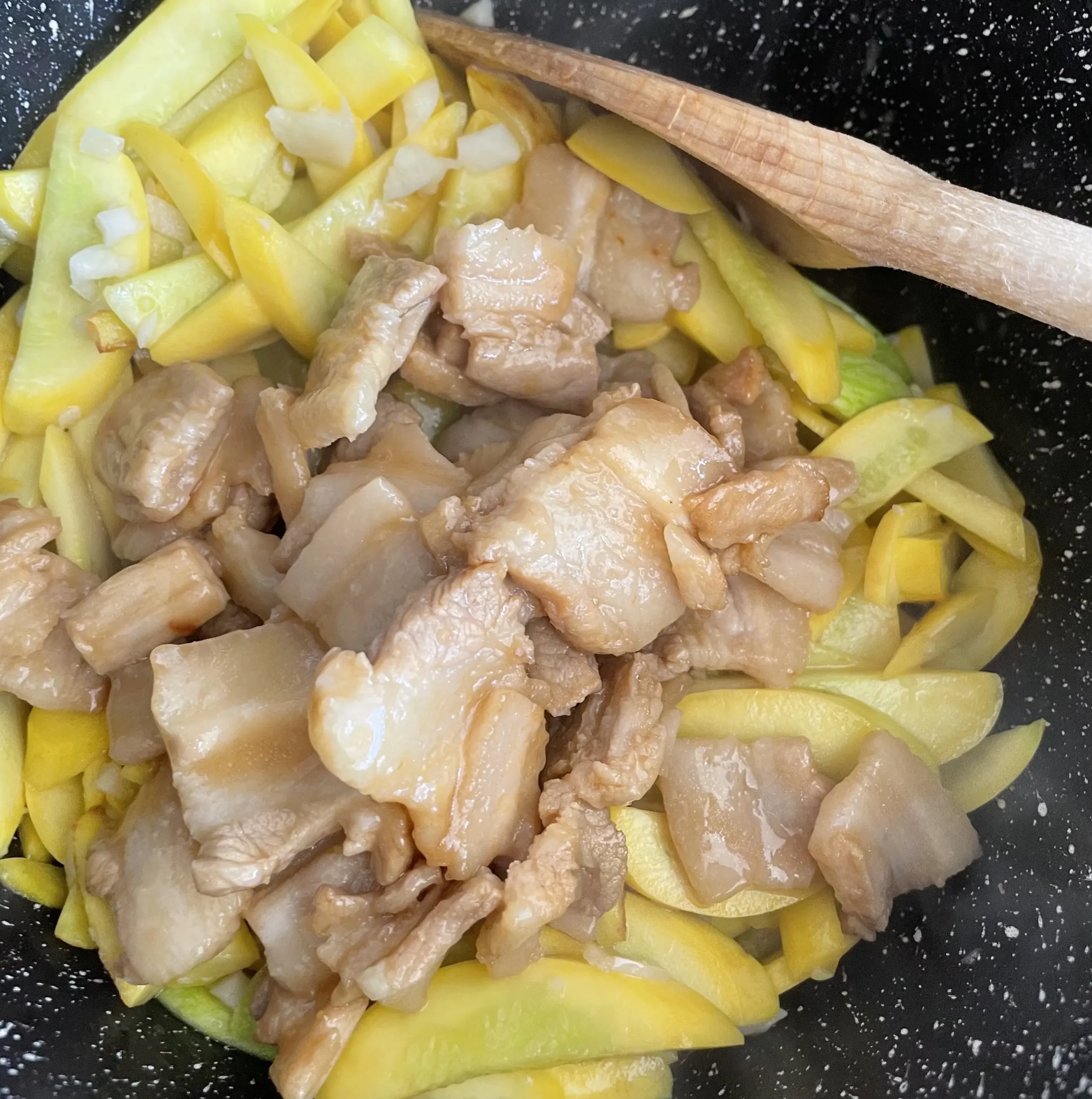 yellow courgette and pork belly stir fry pork and courgettes in pan