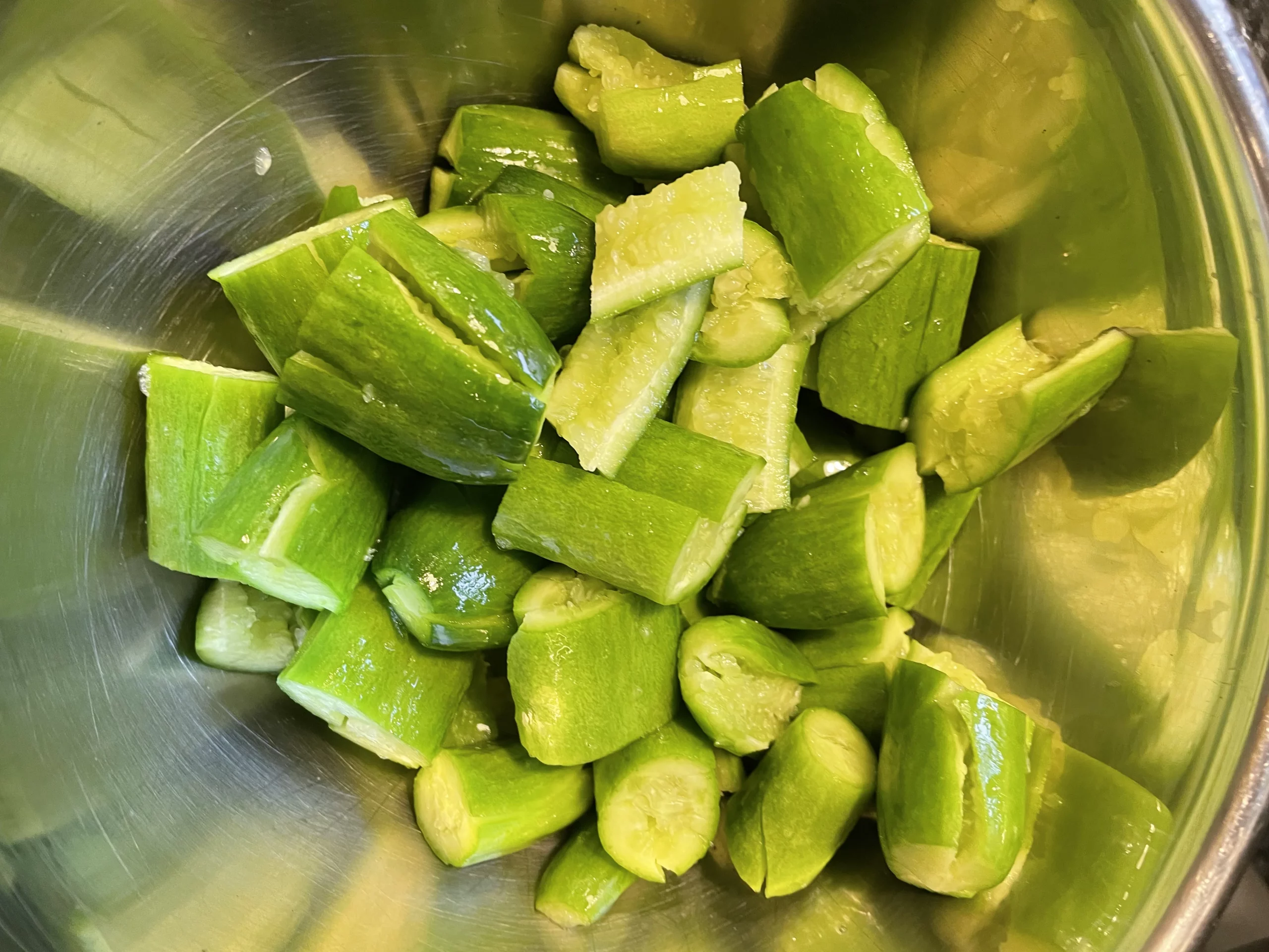 Baby cucumbers chopped and placed in a mixing bowl.