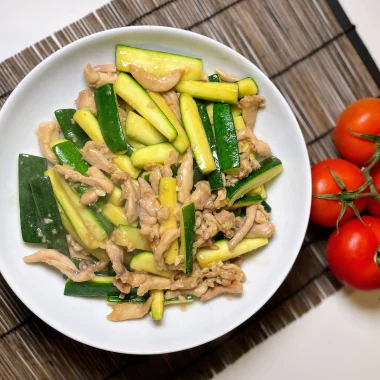 A vibrant plate of chicken courgette stir fry garnished with fresh ingredients, ready to serve.