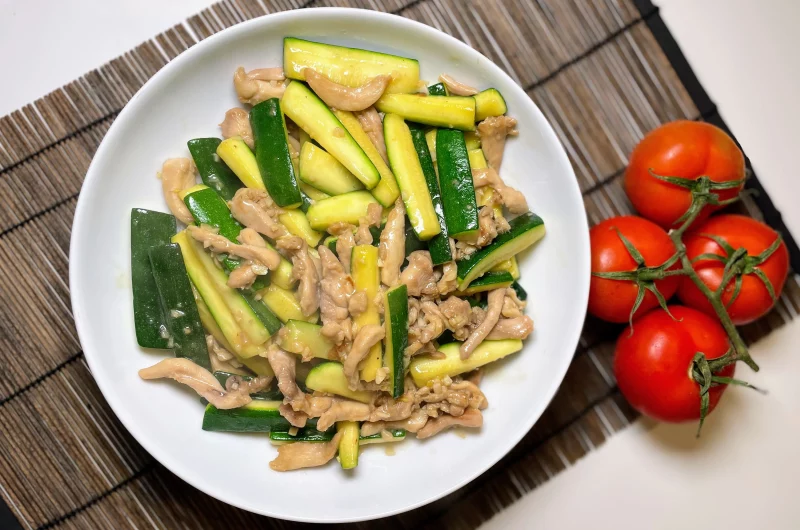 A vibrant plate of chicken courgette stir fry garnished with fresh ingredients, ready to serve.