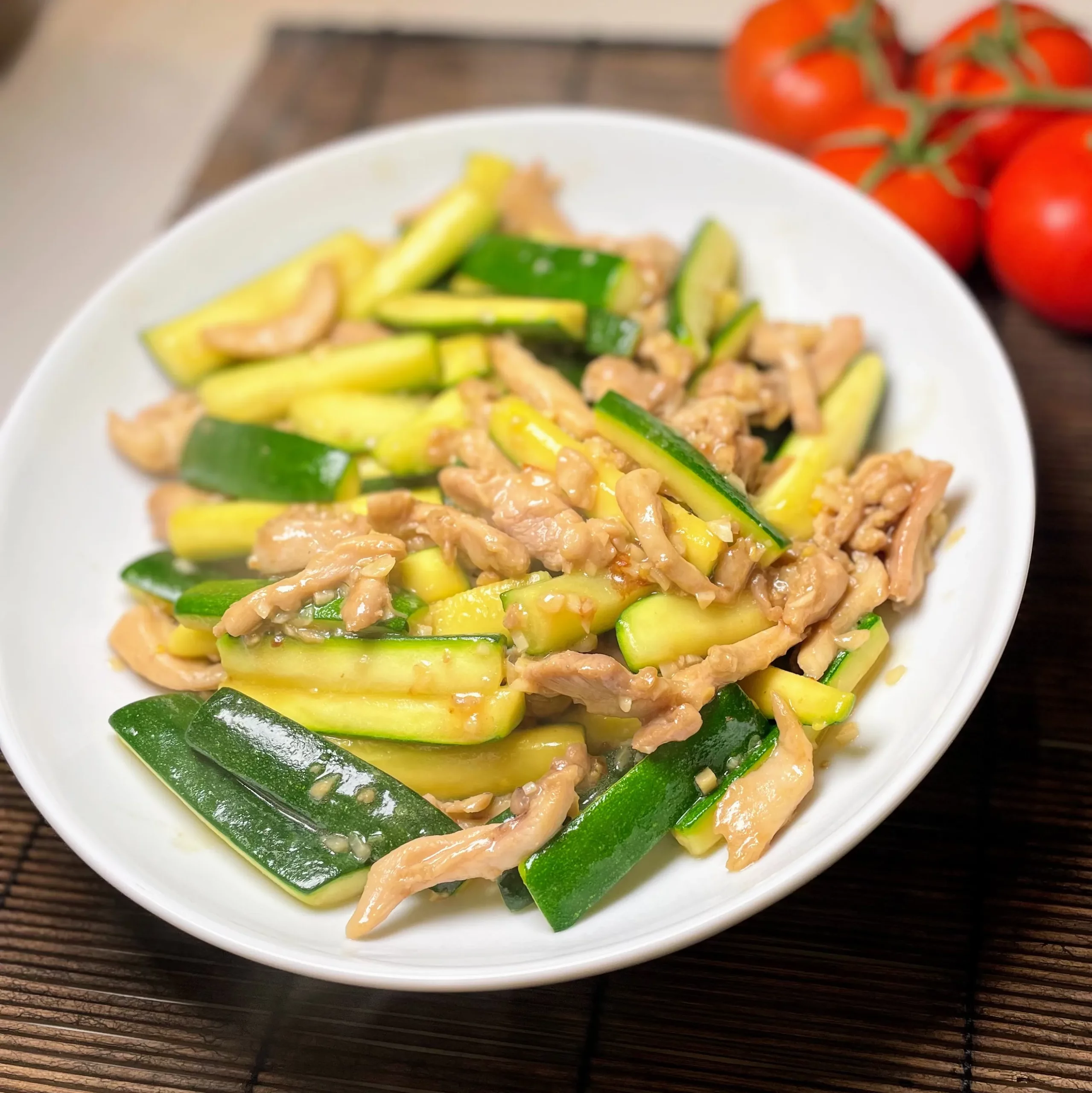 A vibrant plate of chicken courgette stir fry garnished with fresh ingredients, ready to serve.