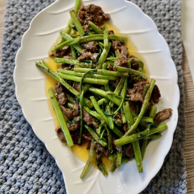 Plated Shacha beef stir-fry with water spinach, served with hot rice