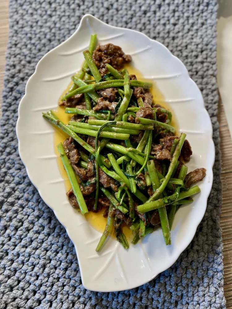 Plated Shacha beef stir-fry with water spinach, served with hot rice