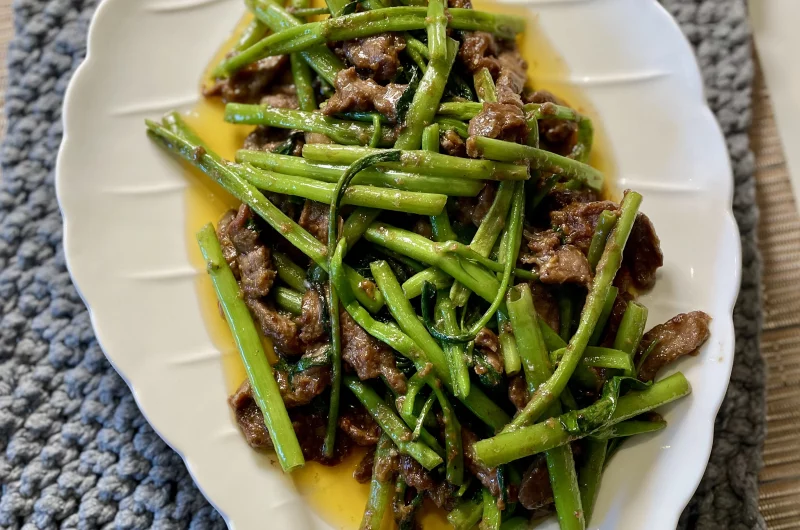 Plated Shacha beef stir-fry with water spinach, served with hot rice