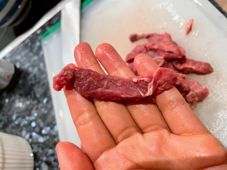 Julienned beef slices prepared for Shacha beef stir-fry